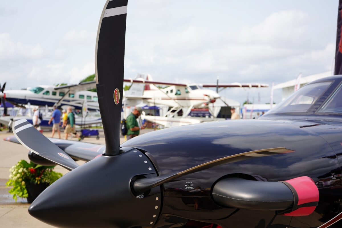 Hartzell propeller on a black plane at OSH 24