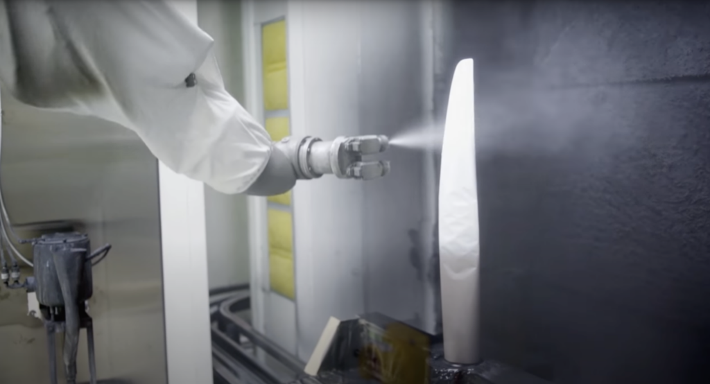Robotic arm painting metal propeller blade